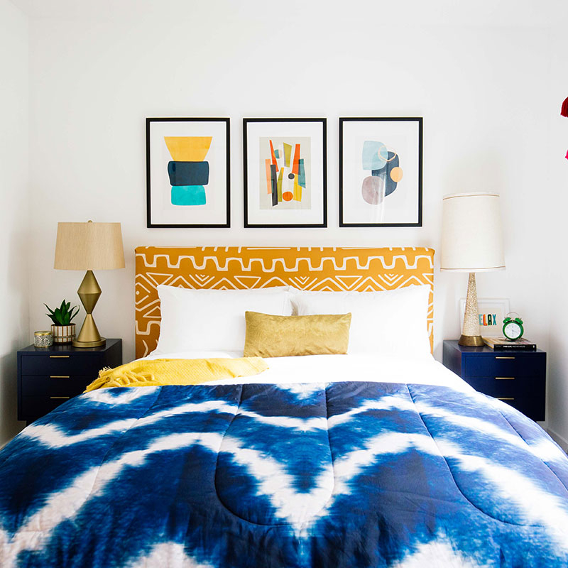 bed with blue and white dye pattern comforter