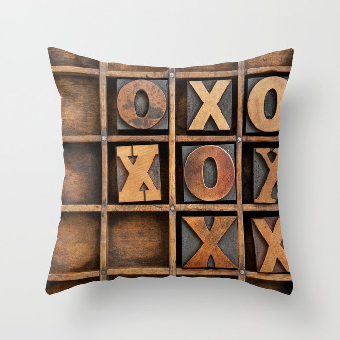 tic-tac-toe or noughts and crosses game - vintage letterpress ing block X and O in wooden grunge typesetter box with dividers Throw Pillow