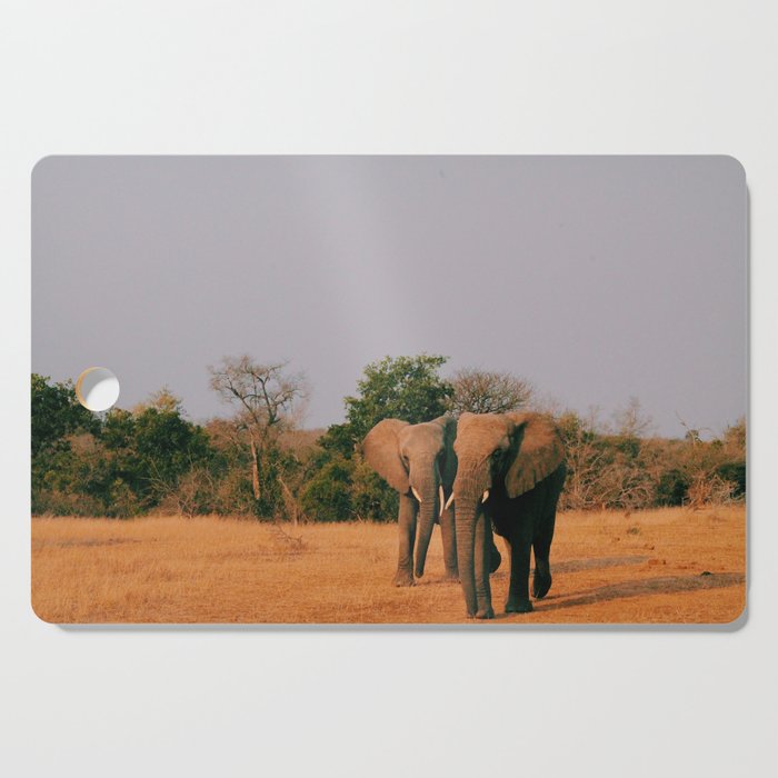 elephants during sunset Cutting Board