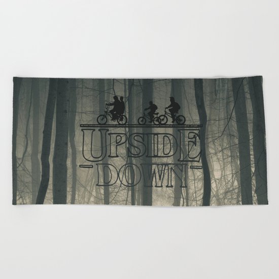 Upside down world Beach Towel