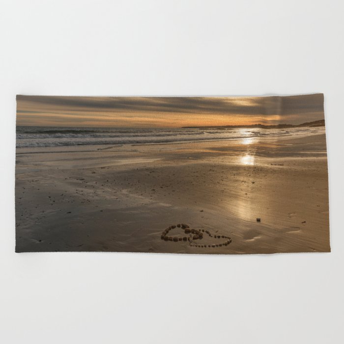 Pebble heart's at sunset Beach Towel