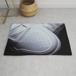White sneakers on a black background Rug