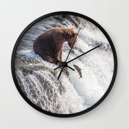 Young grizzly bear sits at waterfall Wall Clock