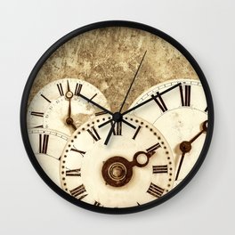 Various vintage clock faces in front of an old concrete wall Wall Clock