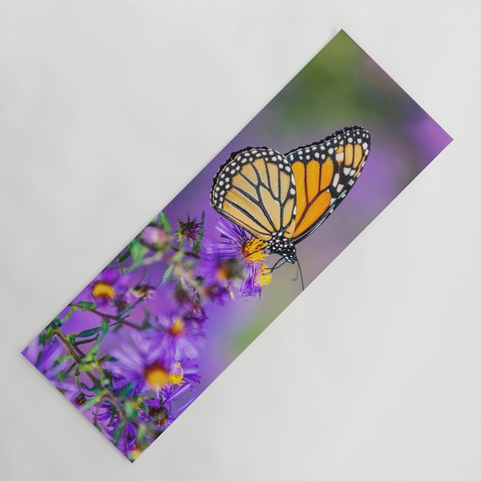 Monarch butterfly on aster purple flowers Yoga Mat