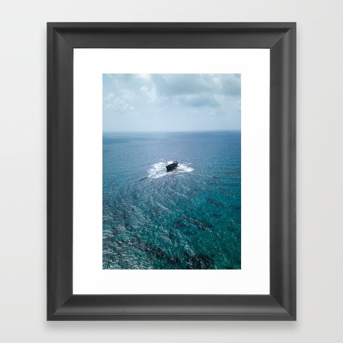 A shipwreck in the middle of the sea Framed Art Print