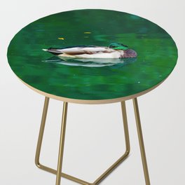 Beautiful elegant duck swimming in green lake water Side Table