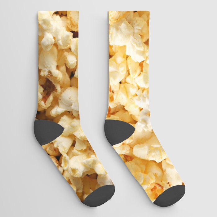 Tasty popcorn on whole background. Food for watching cinema Socks