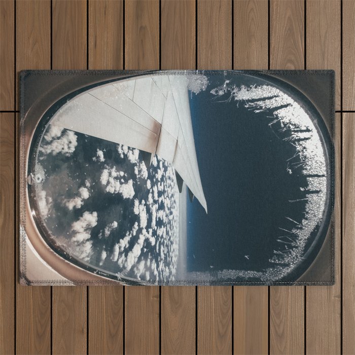 Airplane window and white clouds Outdoor Rug