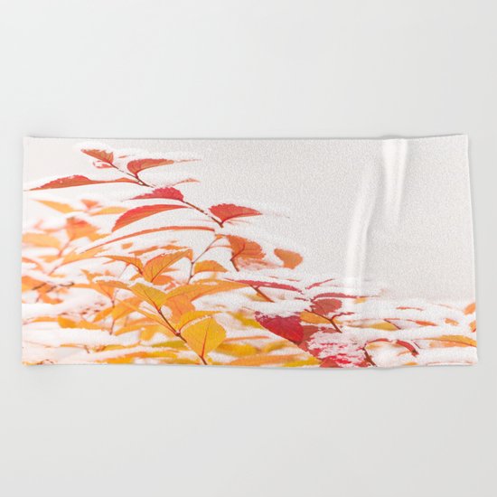 Snow covered red leaves Beach Towel