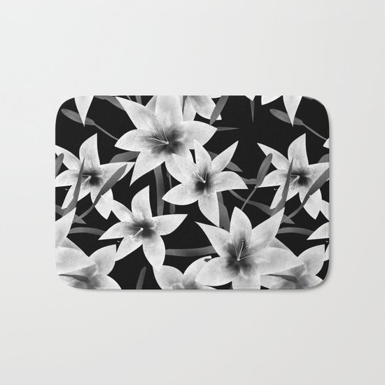 White lilies on a black background . Bath Mat