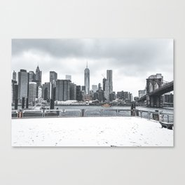 Brooklyn Bridge and Manhattan skyline during winter snowstorm blizzard in New York City Canvas Print