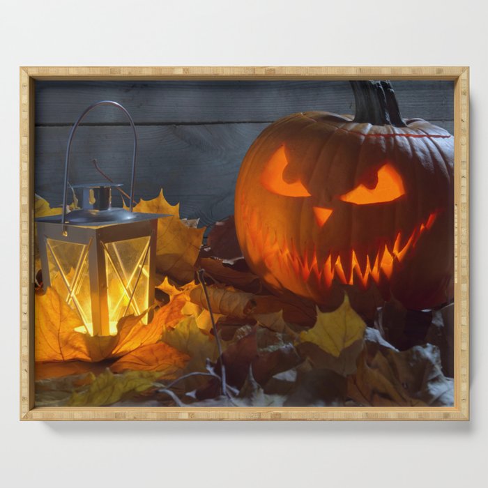 Spooky Jack O Lantern Among Dried Leaves on Wooden Fence Serving Tray