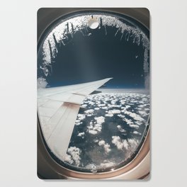 Airplane window and white clouds Cutting Board