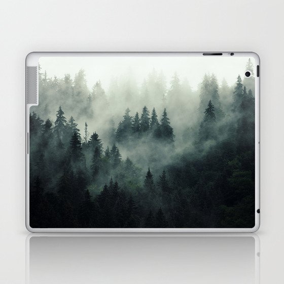 Misty pine forest on the mountain slope in a nature reserve Laptop & iPad Skin