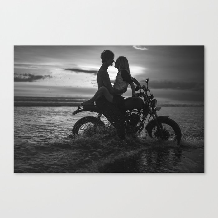 The motorcyclists; lovers at sunset on vintage motorcycle coastal beach romantic portrait black and white photograph - photography - photographs by Yuliya Kirayonak Canvas Print