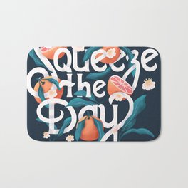 Squeeze the day lettering illustration with oranges on dark blue background. Hand lettering; fruit and floral design in bright colors.  Bath Mat