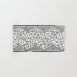 White color straight strip of lace fabric on gray background. Elastic silk nylon braid border. Hand & Bath Towel