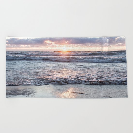Crashing waves and a golden sunset Beach Towel