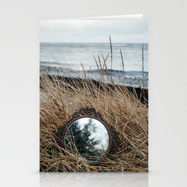 Vintage mirror on seaside reflects forest and sky. Stationery Cards