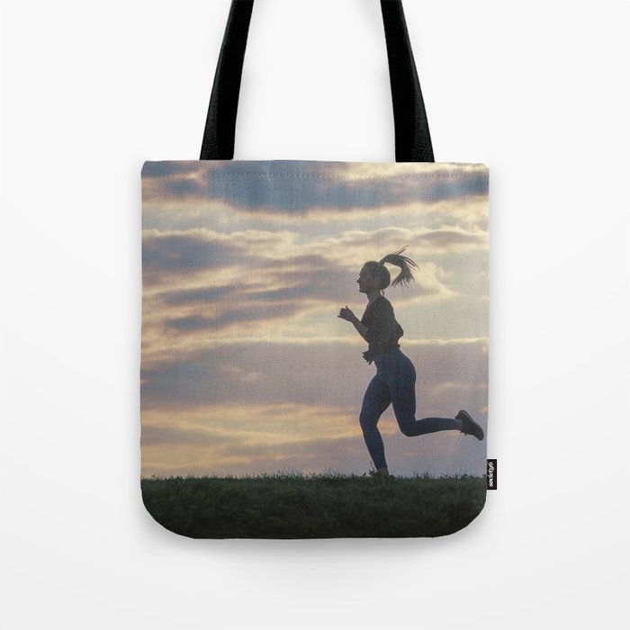 Running woman morning workout. Female Runner. Jogging during sunrise. Workout in a Park. Sporty Tote Bag