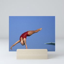 Woman diver flying through the air. Mini Art Print