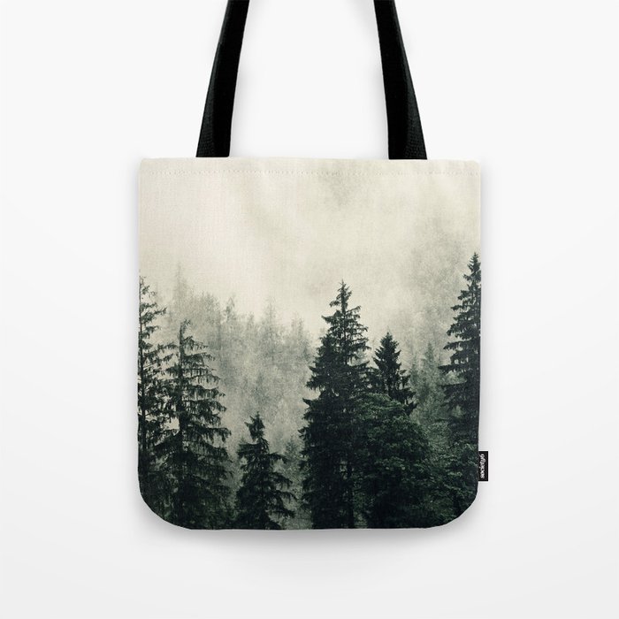 Thick pine forest in the descending mist Tote Bag