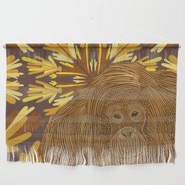 Orangutan in the jungle sitting on a brown abstract leafy pattern background Wall Hanging