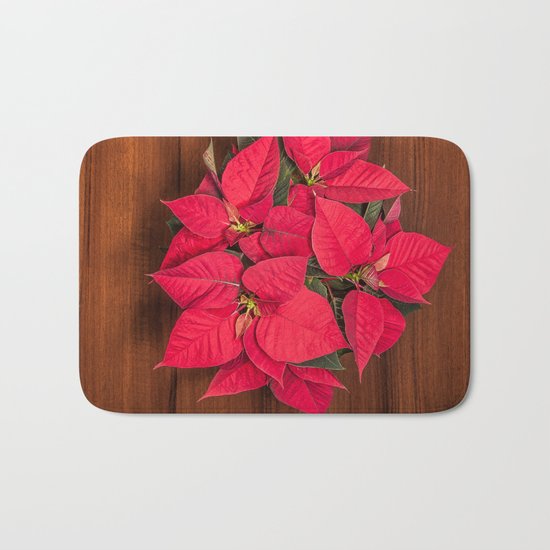 Red Christmas flower on brown wood Bath Mat