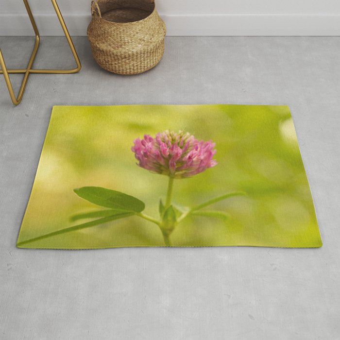 Red clover on green blur nature background #decor #society6 #buyart Rug