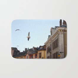 Seagulls flying over Annecy, Haute-Savoie, France | Travel Photography Bath Mat | Photo, Seagull, Hautesavoie, Vieilleville, Digital, Village, Flyingseagull, Travel, Color, Flying 