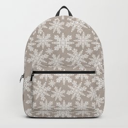 Winter coziness. Snowflakes. Pale old beige background. Backpack