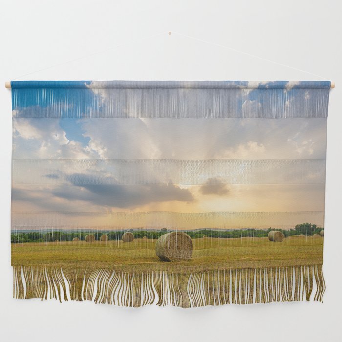 The Best of Times - Round Hay Bales Under a Stormy Sky Filled with Golden Sunlight in Oklahoma Wall Hanging