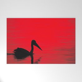 A pelican silhouette, red dawn - landscape Welcome Mat