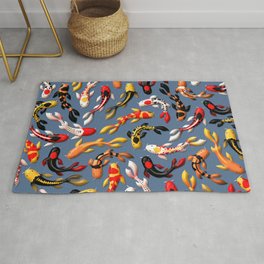 Pattern of colorful Japanese koi fish before simple dark blue background Rug
