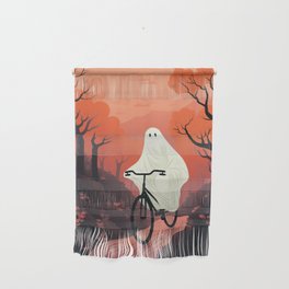 cute ghost riding a bike through autumn nature landscape Wall Hanging