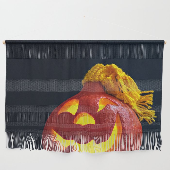 Glowing Pumpkin with Autumn Leaves on a Dark Background. Jack's Lantern. Halloween Decoration Wall Hanging