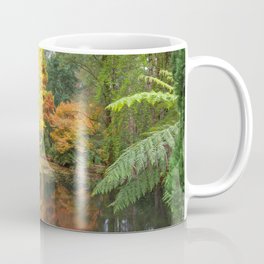 Beautiful pond with golden trees reflections in calm waters. Melbounre, Australia. Coffee Mug