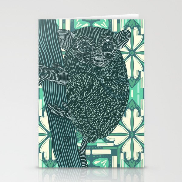Bush baby sitting on tree stump with light green pattern background Stationery Cards