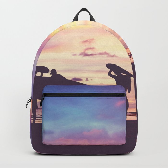 Silhouette Of surfer people carrying their surfboard on sunset beach, vintage filter effect with soft style Backpack