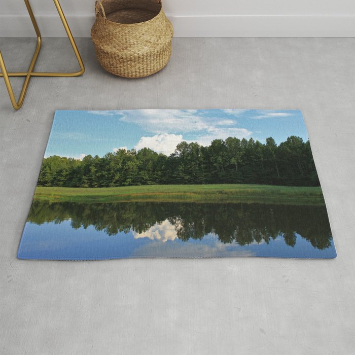 Clouds over a pond Rug