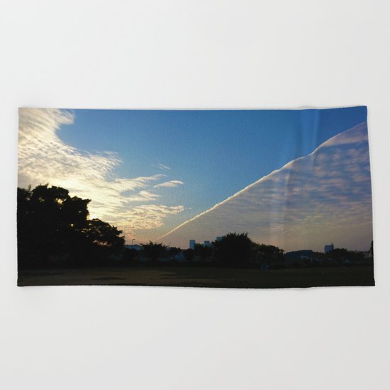 drama in the sky Beach Towel