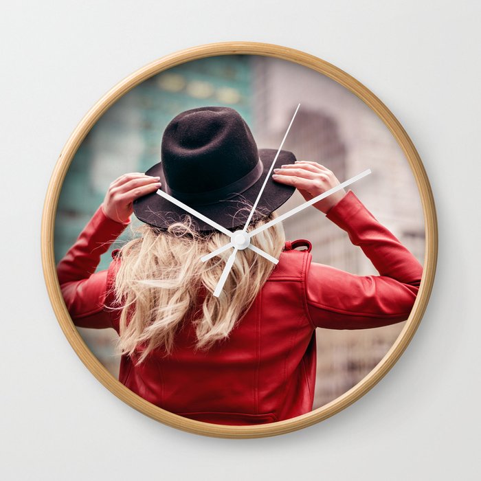 A young woman wearing a hat is walking in the streets of New York City Wall Clock