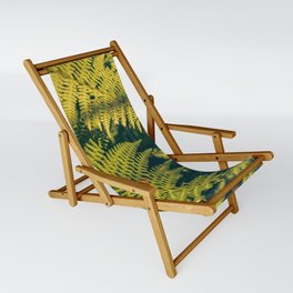 A green fern plants background with shadows.  Sling Chair