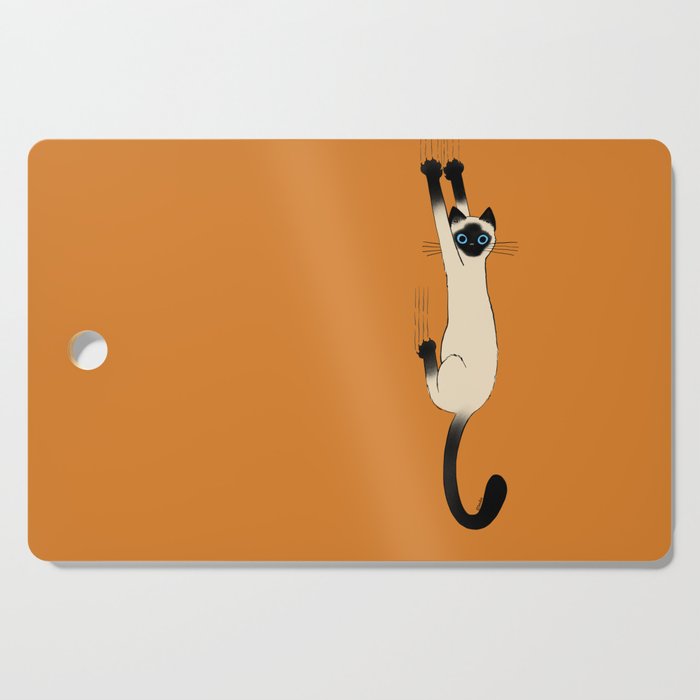 Siamese Cat Hanging On Cutting Board