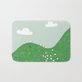 a hill full of sheep Bath Mat