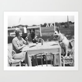 Dog day afternoon; young female flapper with German shepherds behaving badly at outdoor table vintage black and white photograph - photography - photographs  Art Print