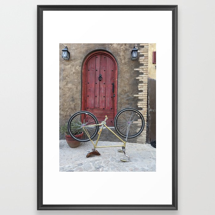 Yellow bike with red door on background Framed Art Print