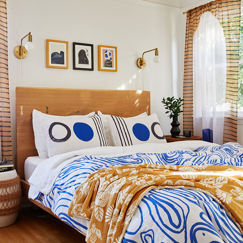 bed with blue and white abstract comforter