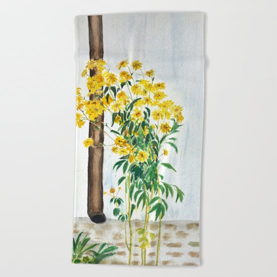 sun choke flowers outside a house Beach Towel
